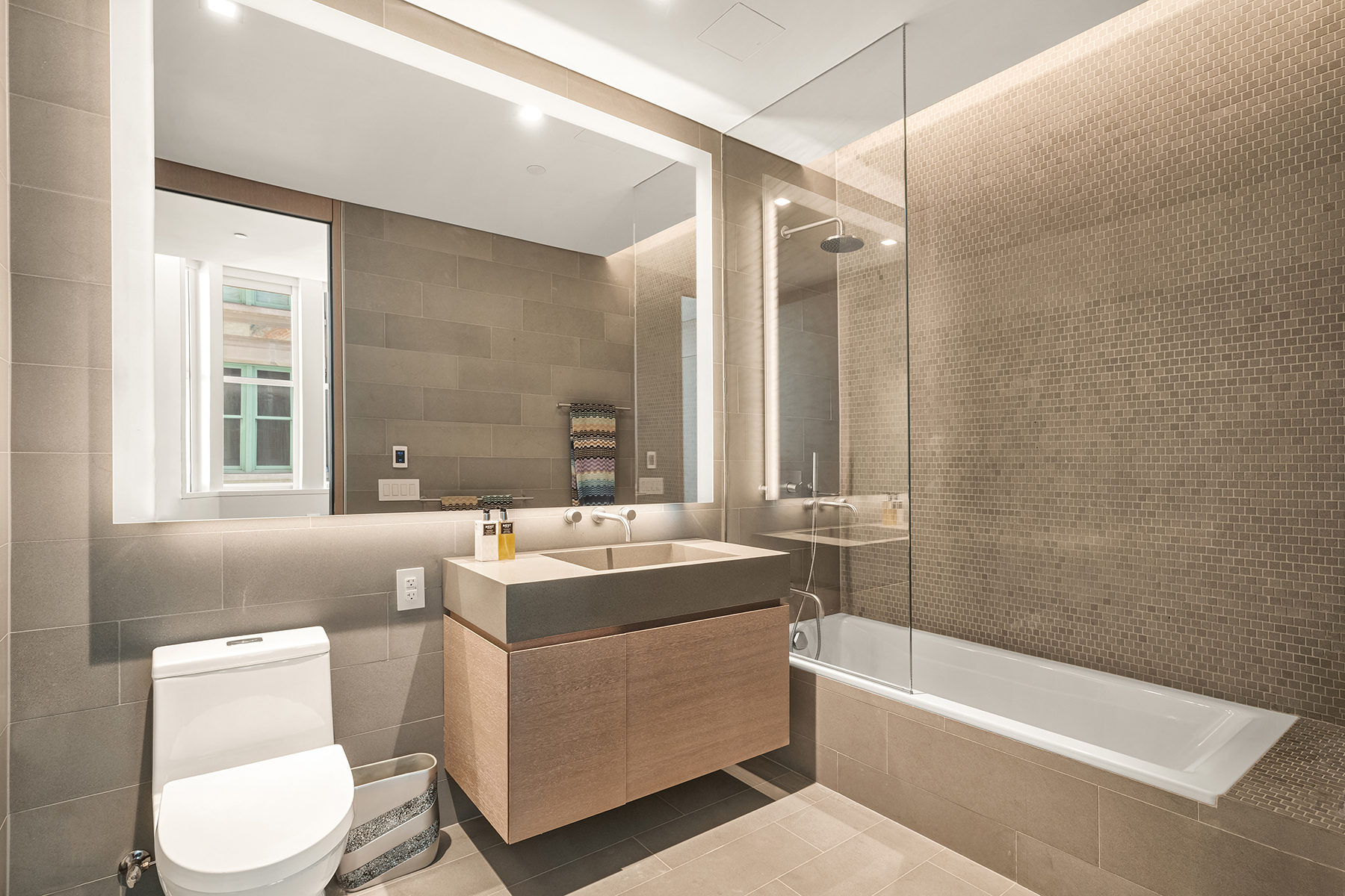 49 Chambers Street, Unit 15B Manhattan, NY 10007 - Photo 7 of 20 a bathroom with a sink toilet vanity and bathtub