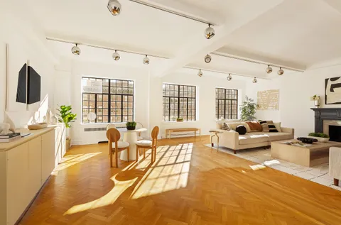 a living room with fireplace furniture and a flat screen tv