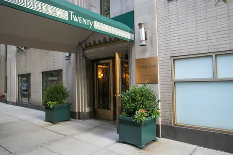 a view of a house with potted plants