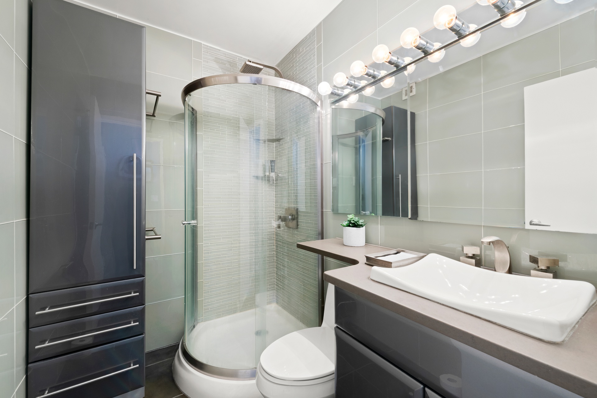 20 East 9th Street, Unit 9R Manhattan, NY 10003 - Photo 8 of 22 a bathroom with a sink a toilet and shower