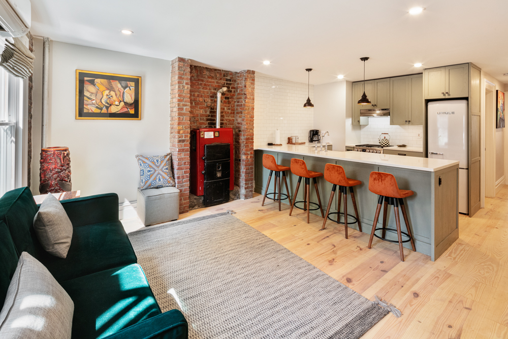 333 Prospect Avenue, Unit G Brooklyn, NY 11215 - Photo 2 of 8 a living room with stainless steel appliances kitchen island granite countertop furniture wooden floor and a kitchen view