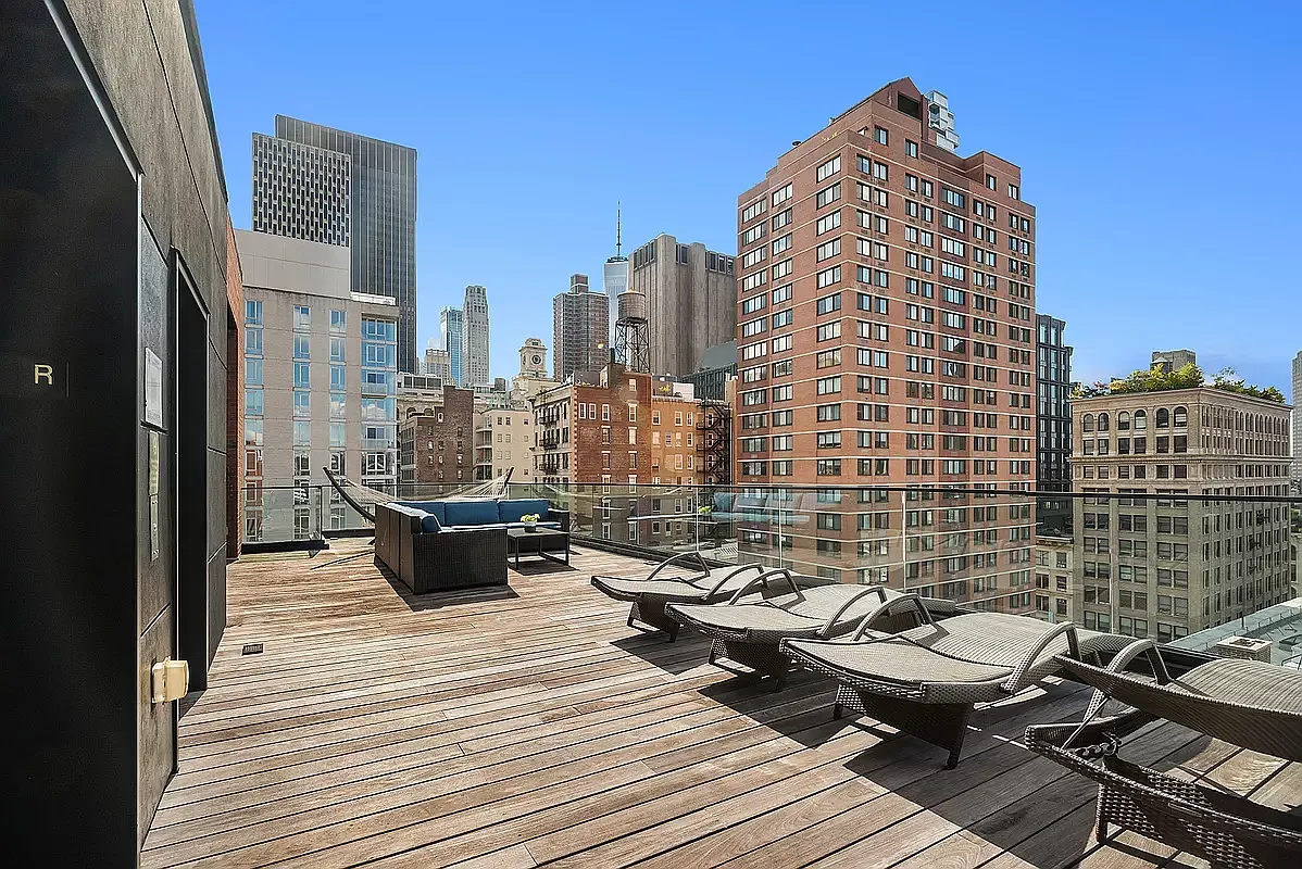 a view of roof deck with wooden floor and city view