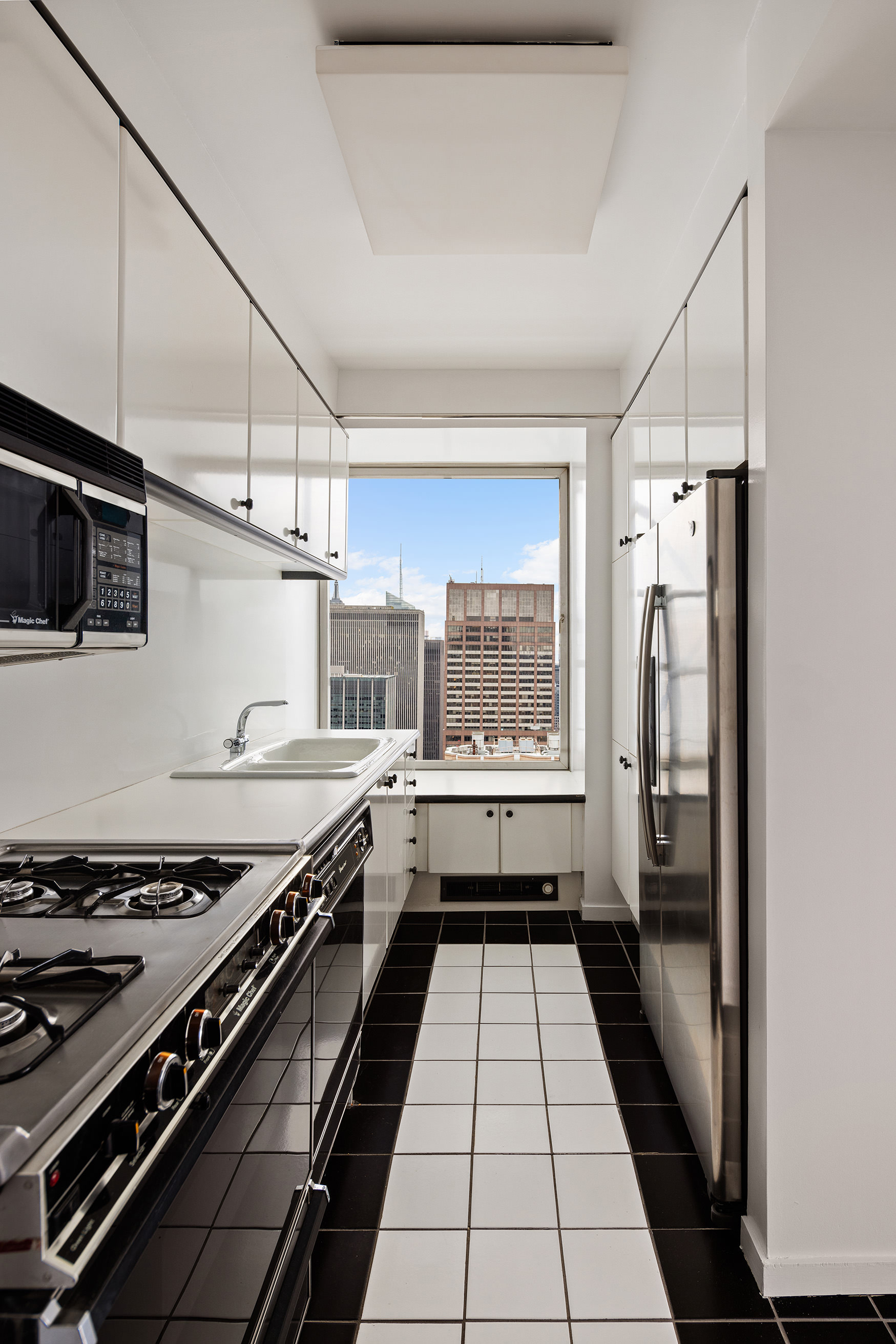 150 West 56th Street, Unit 6204 Manhattan, NY 10019 - Photo 9 of 15 a kitchen with a stove and a refrigerator