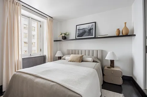 a bedroom with bed and window