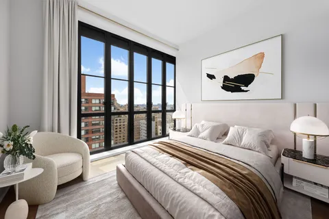 a bedroom with a large bed and a couch