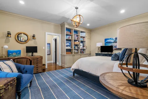 a bedroom with bed and wooden floor