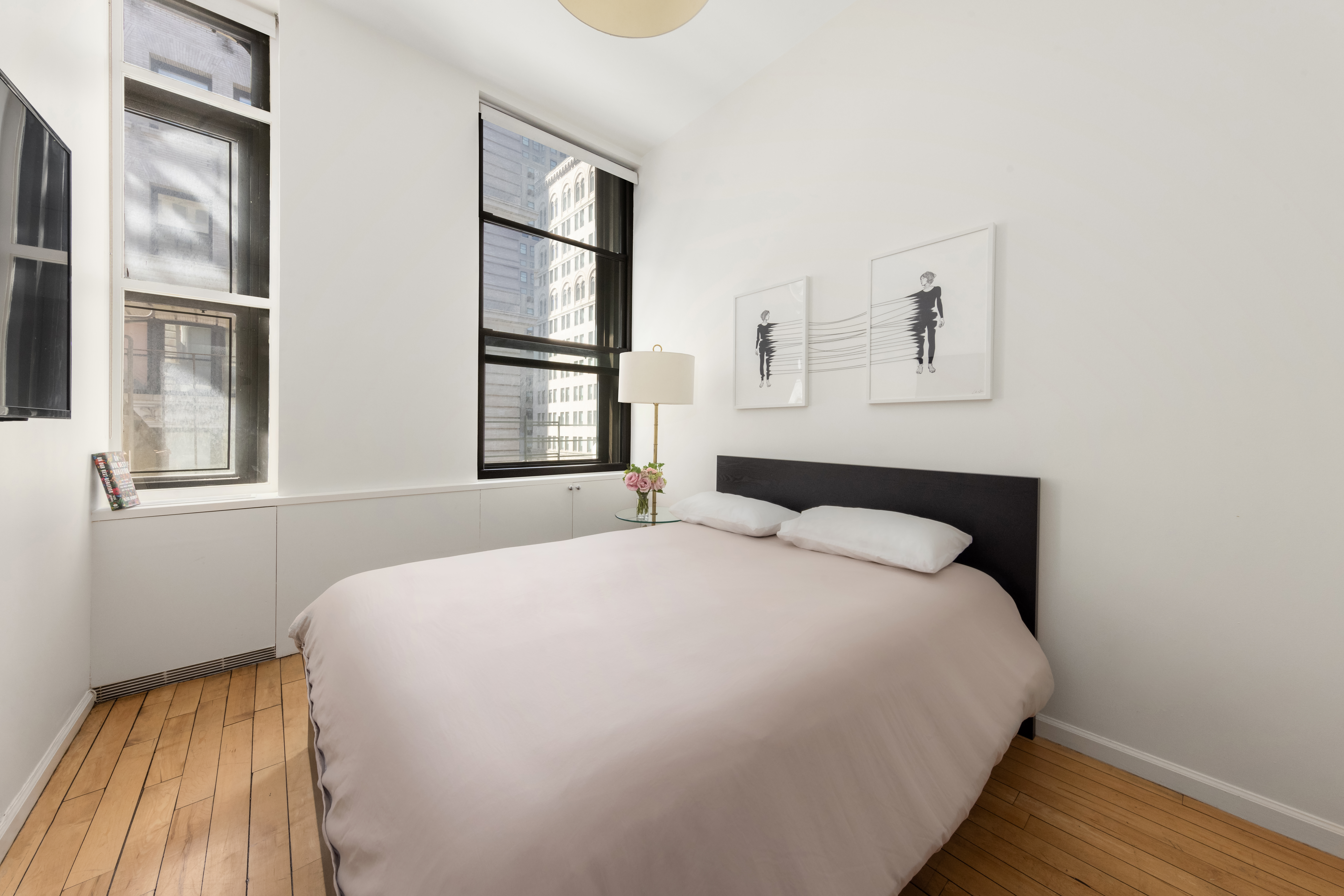 65 Leonard Street, Unit 4 Manhattan, NY 10013 - Photo 9 of 10 a bedroom with a bed and a window