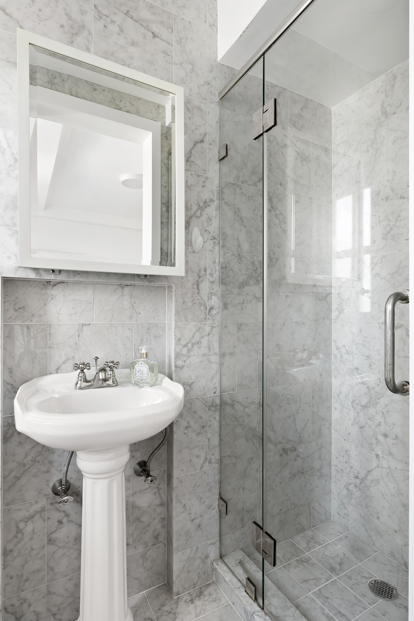 425 East 86th Street, Unit 11E Manhattan, NY 10028 - Photo 13 of 19 a bathroom with a sink shower and a mirror
