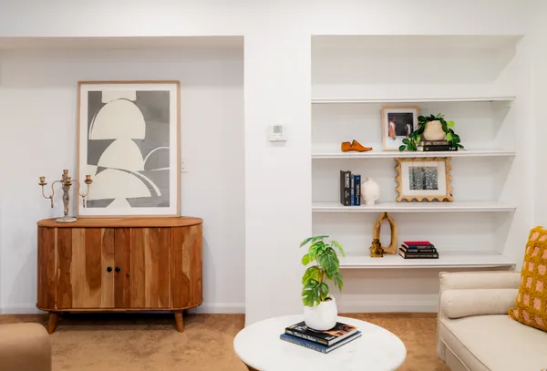 a living room with furniture and a potted plant