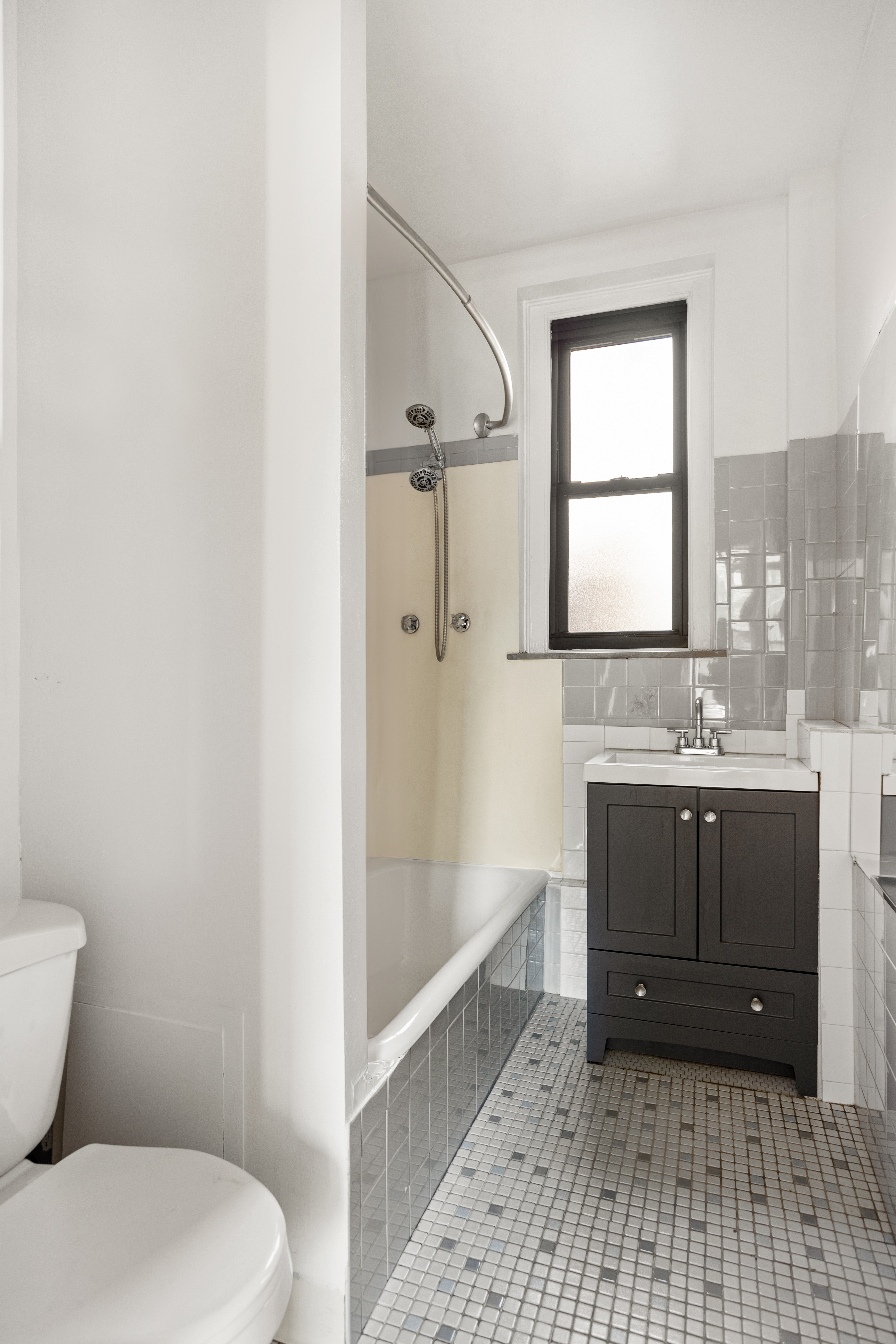 35-30 82nd Street, Unit 32 Queens, NY 11372 - Photo 9 of 11 a bathroom with a sink a toilet and shower