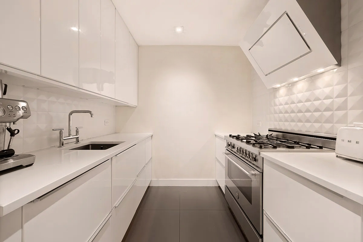 138 North 3rd Street, Unit 1 Brooklyn, NY 11249 - Photo 7 of 9 a kitchen with stainless steel appliances a sink stove and cabinets
