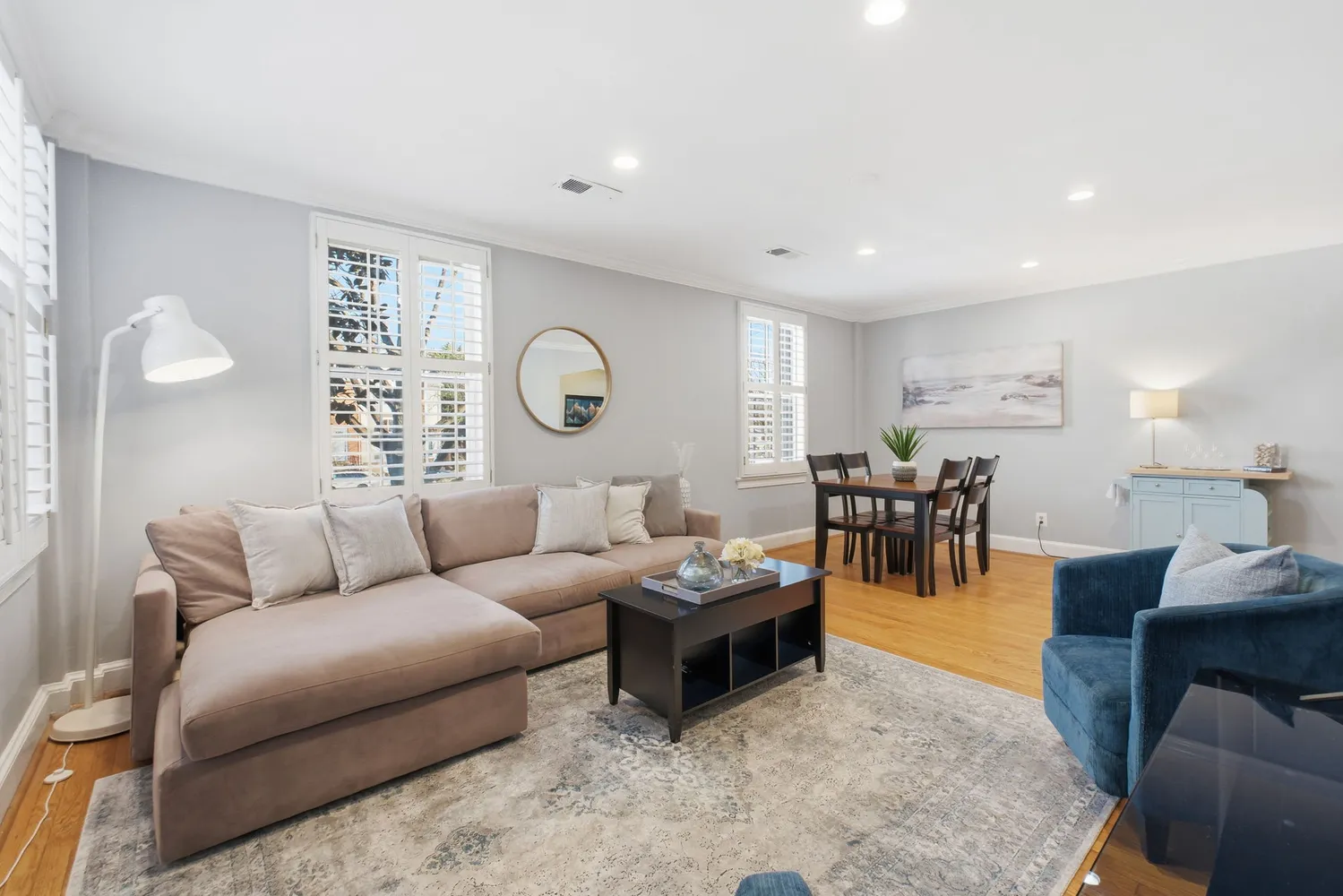 a living room with furniture and wooden floor
