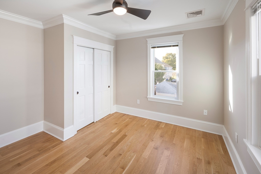 48-50 Amsden Street, Unit 2 Arlington, MA 02474 - Photo 17 of 34 a view of an empty room with wooden floor and a window