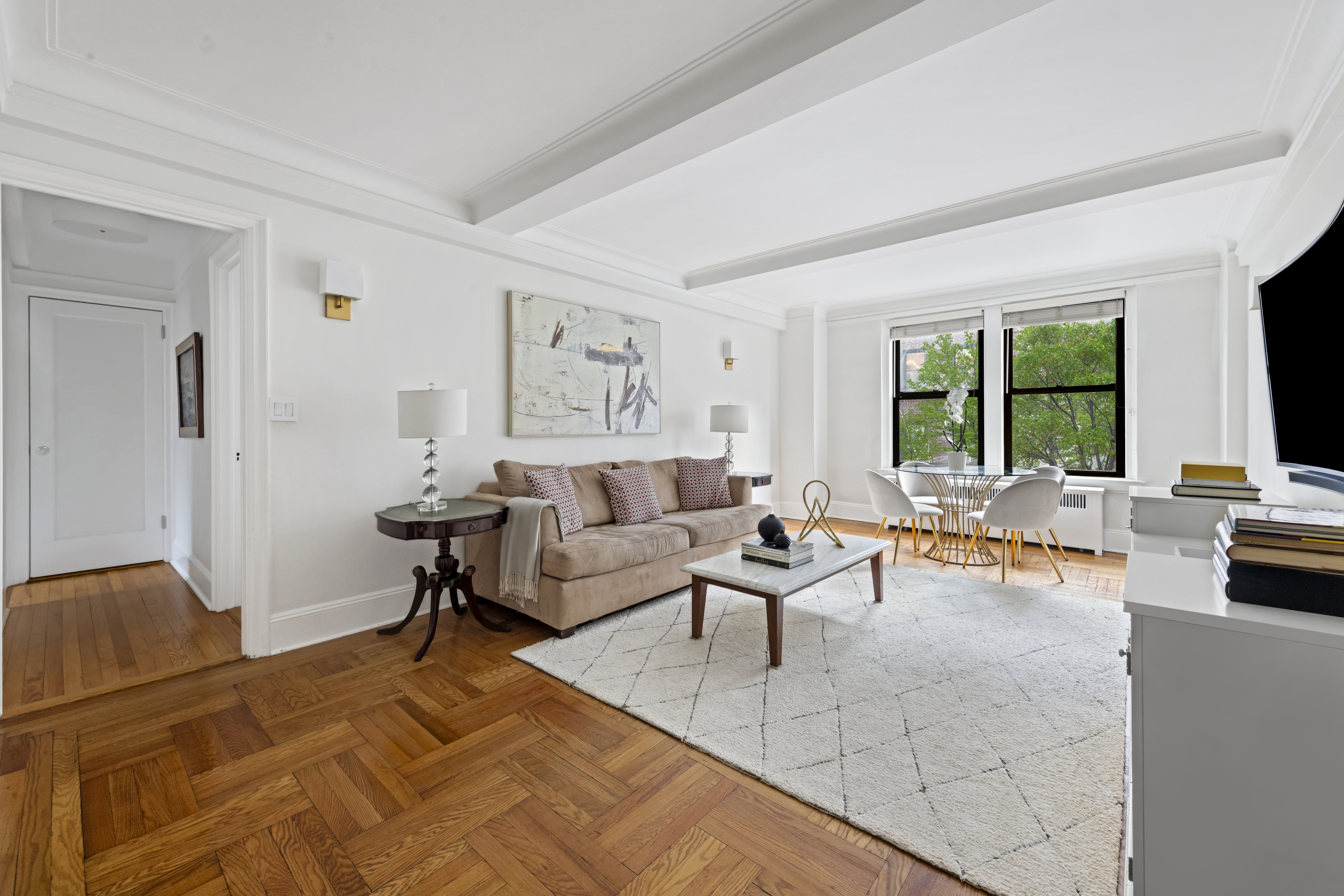 333 East 53rd Street, Unit 3KL Manhattan, NY 10022 - Photo 2 of 10 a living room with furniture and a large window