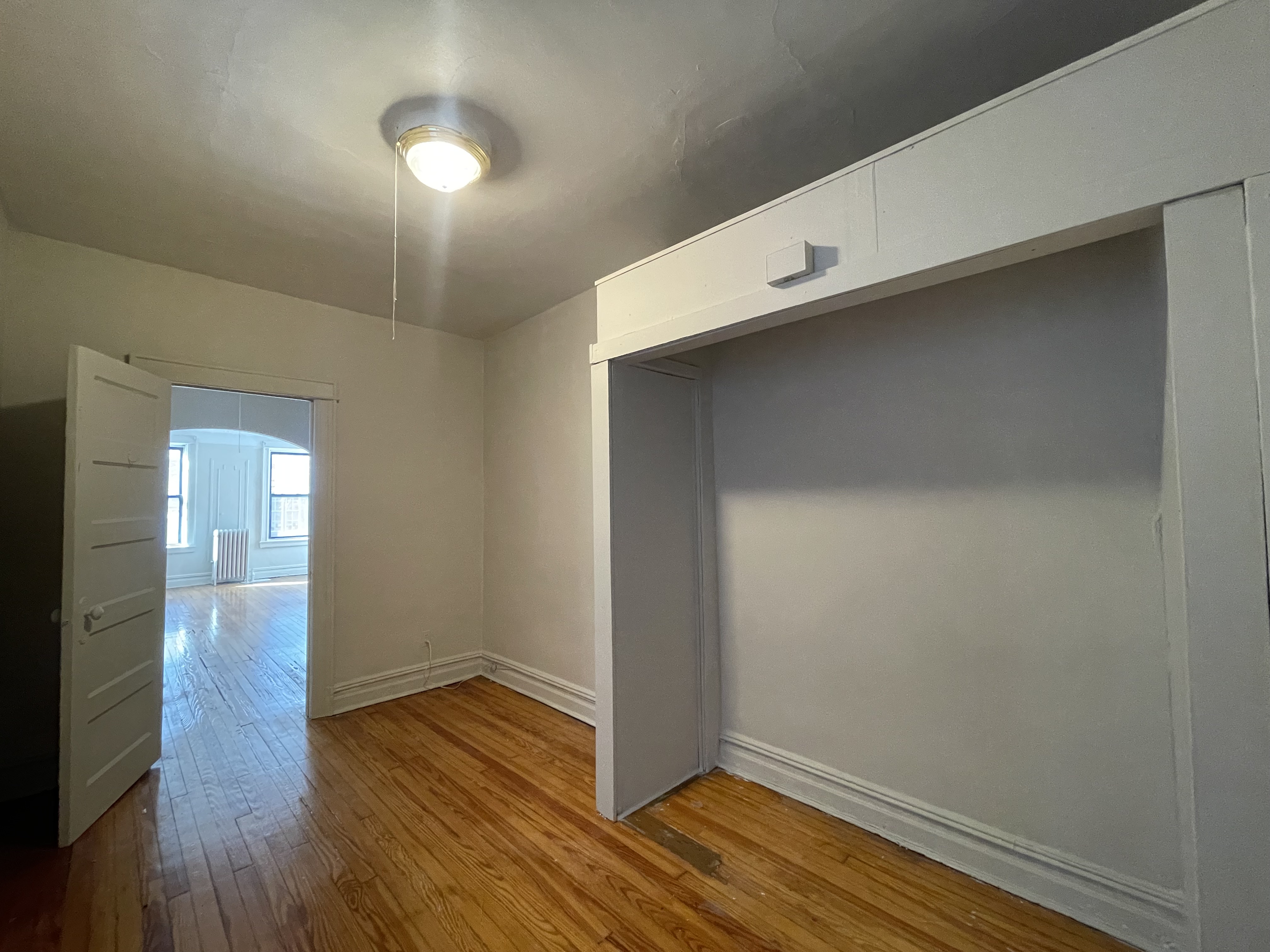 68-43 Fresh Pond Road, Unit 2R Queens, NY 11385 - Photo 3 of 6 a view of an empty room with wooden floor