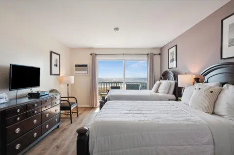 a bedroom with a bed and a flat screen tv