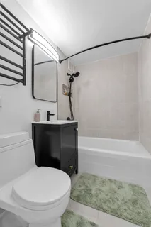 a bathroom with a sink a toilet and a mirror