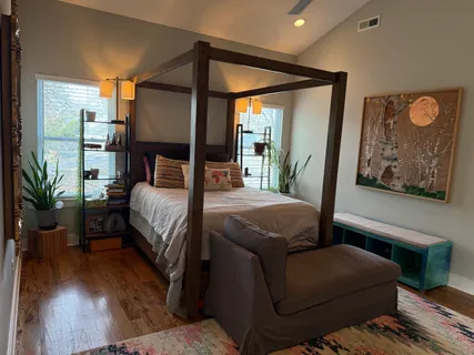 a bedroom with a bed window and a potted plant