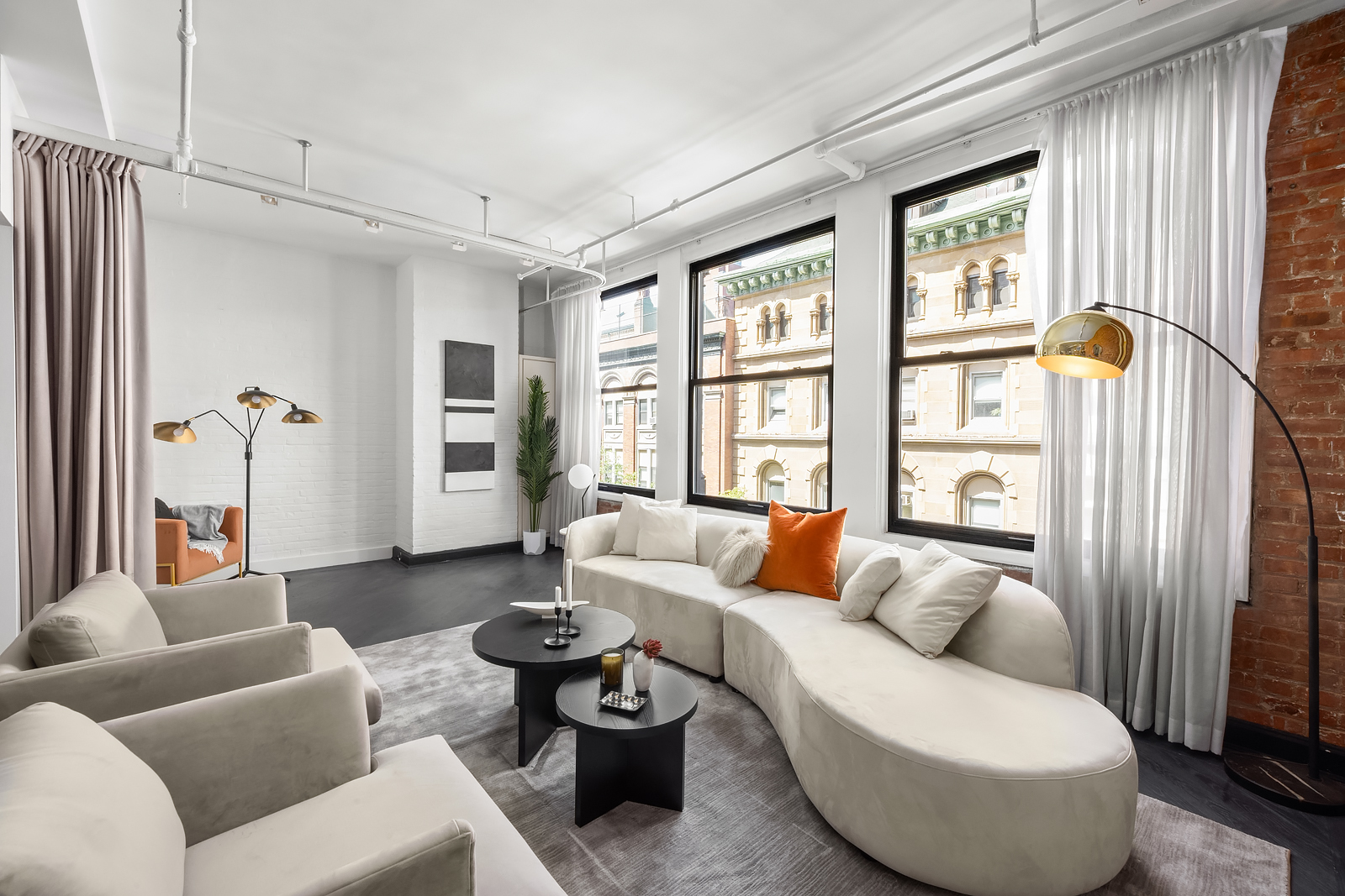 36 West 15th Street, Unit 4 Manhattan, NY 10011 - Photo 3 of 21 a living room with furniture and a large window