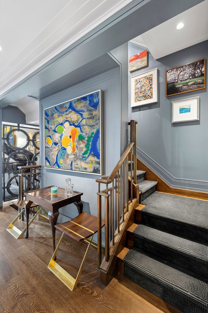 a room with gym equipment and lots of frames on wall