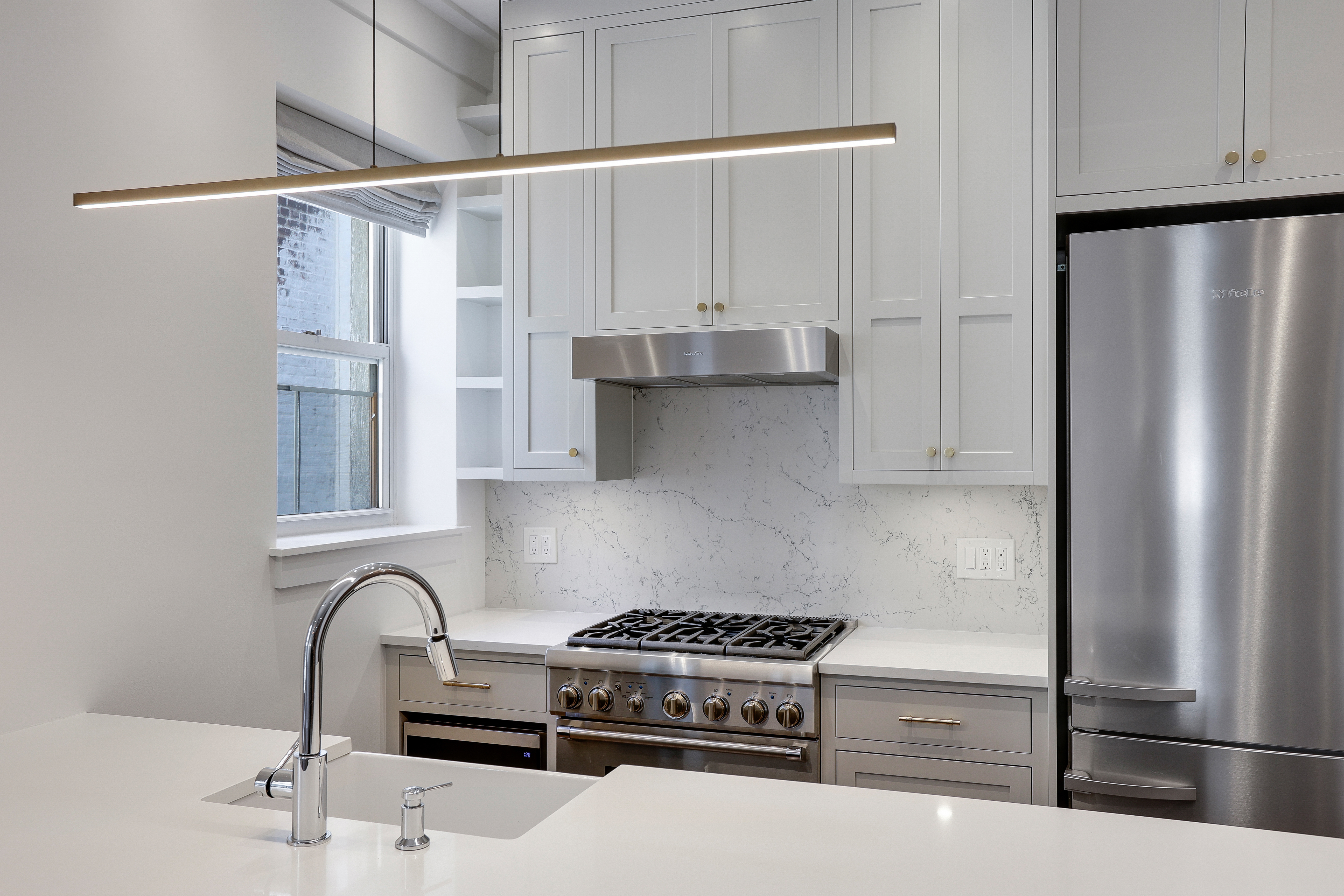 133 East 30th Street, Unit PH5B Manhattan, NY 10016 - Photo 3 of 24 a kitchen with stainless steel appliances granite countertop a refrigerator and a stove