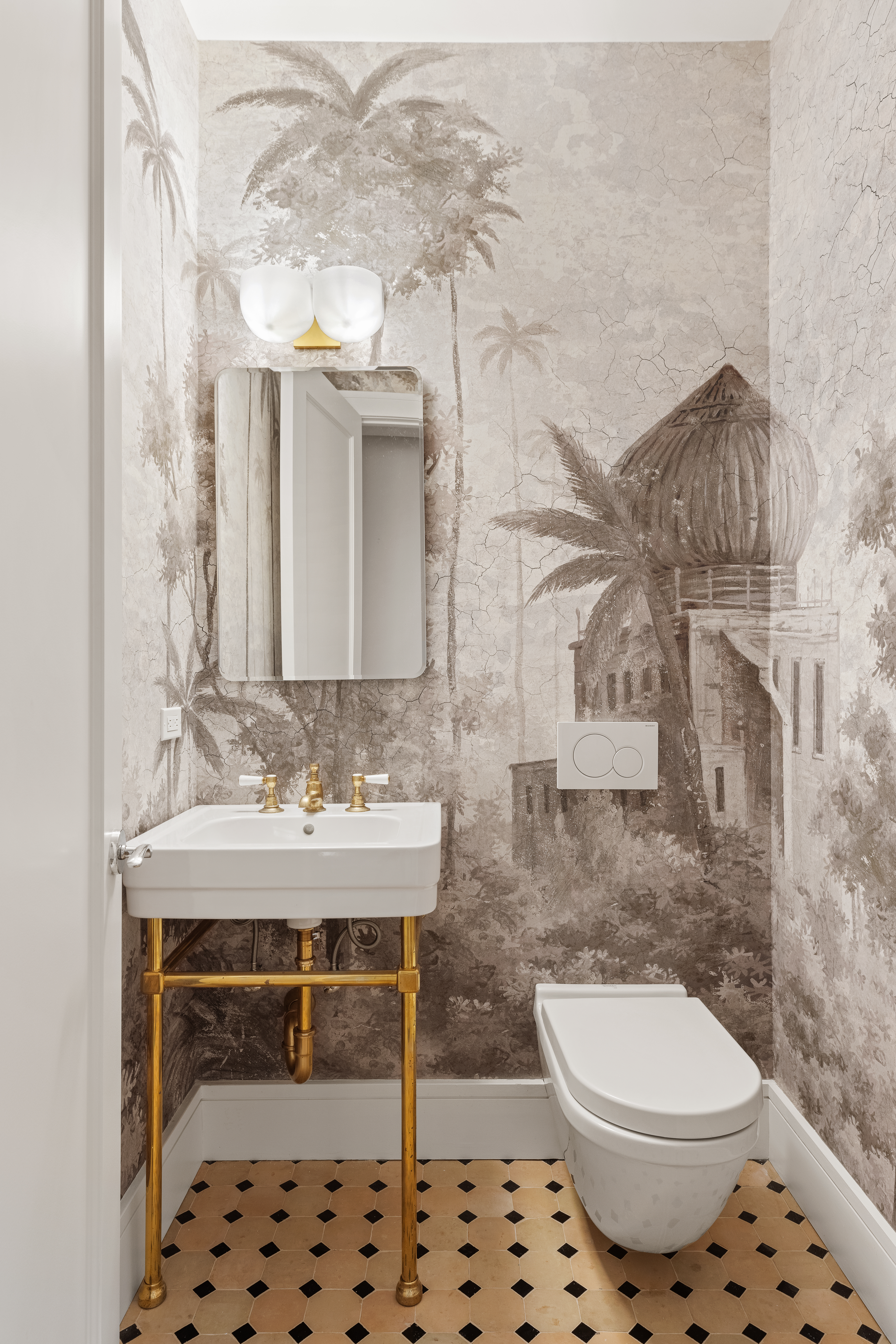 169 Spring Street, Unit 2W Manhattan, NY 10012 - Photo 6 of 11 a bathroom with a sink a toilet and a mirror