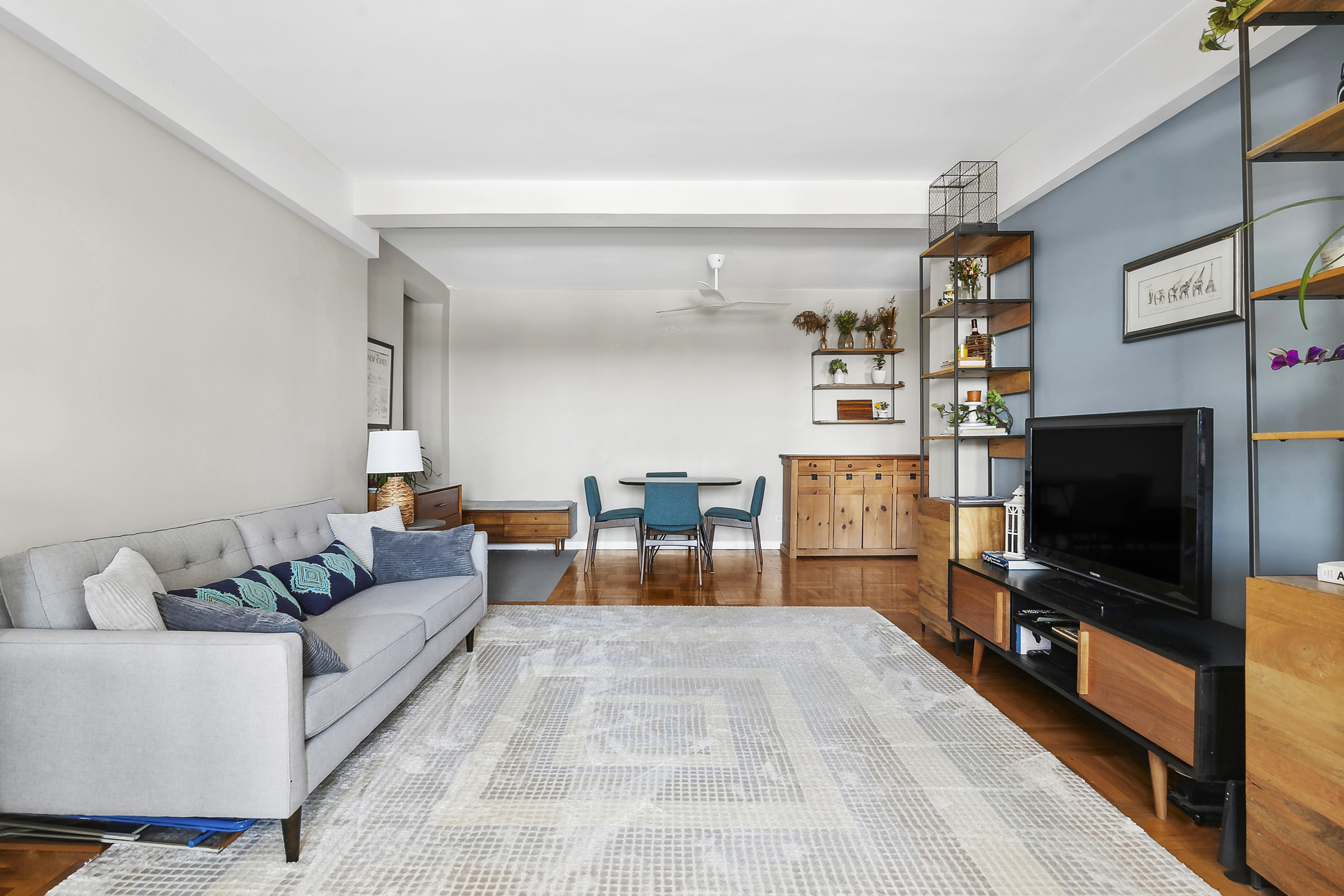 303 Beverley Road, Unit 10E Brooklyn, NY 11218 - Photo 3 of 11 a living room with furniture and a flat screen tv