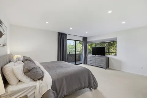a bedroom with a large bed and a flat screen tv