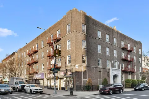 a city street lined with buildings and cars parked on the street