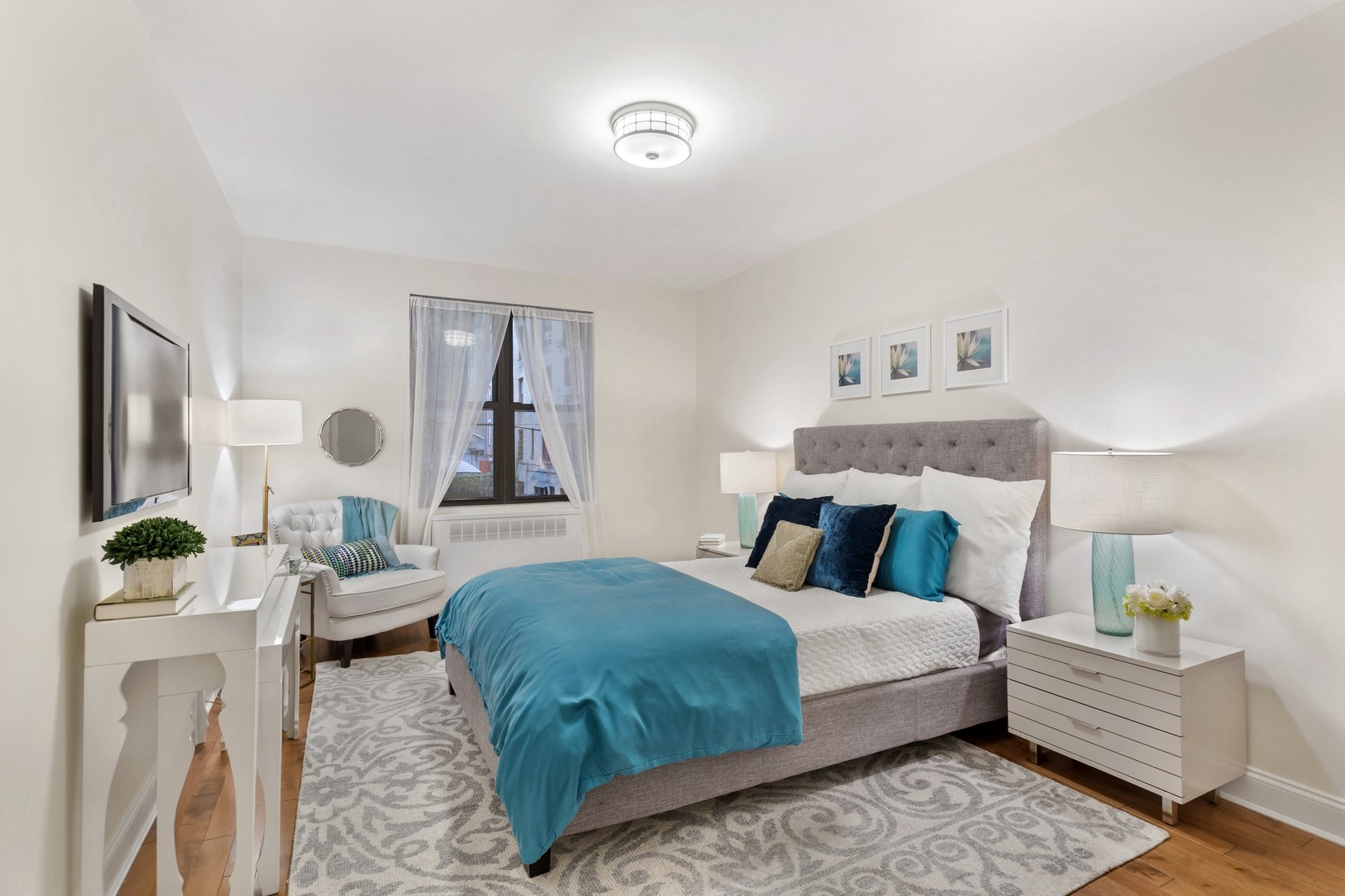 345 Riverside Drive, Unit 1E Manhattan, NY 10025 - Photo 3 of 5 a bedroom with a large bed and a window