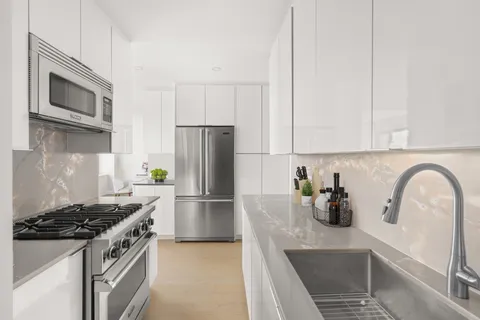 a kitchen with a refrigerator and a sink
