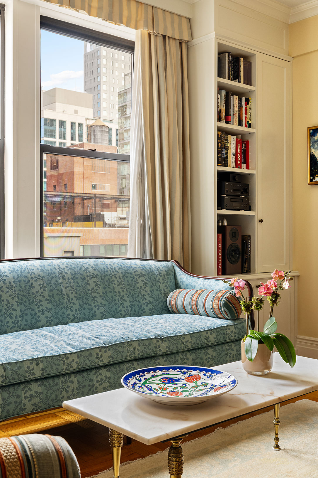 119 East 84th Street, Unit 9C Manhattan, NY 10028 - Photo 2 of 10 a living room with furniture and a window