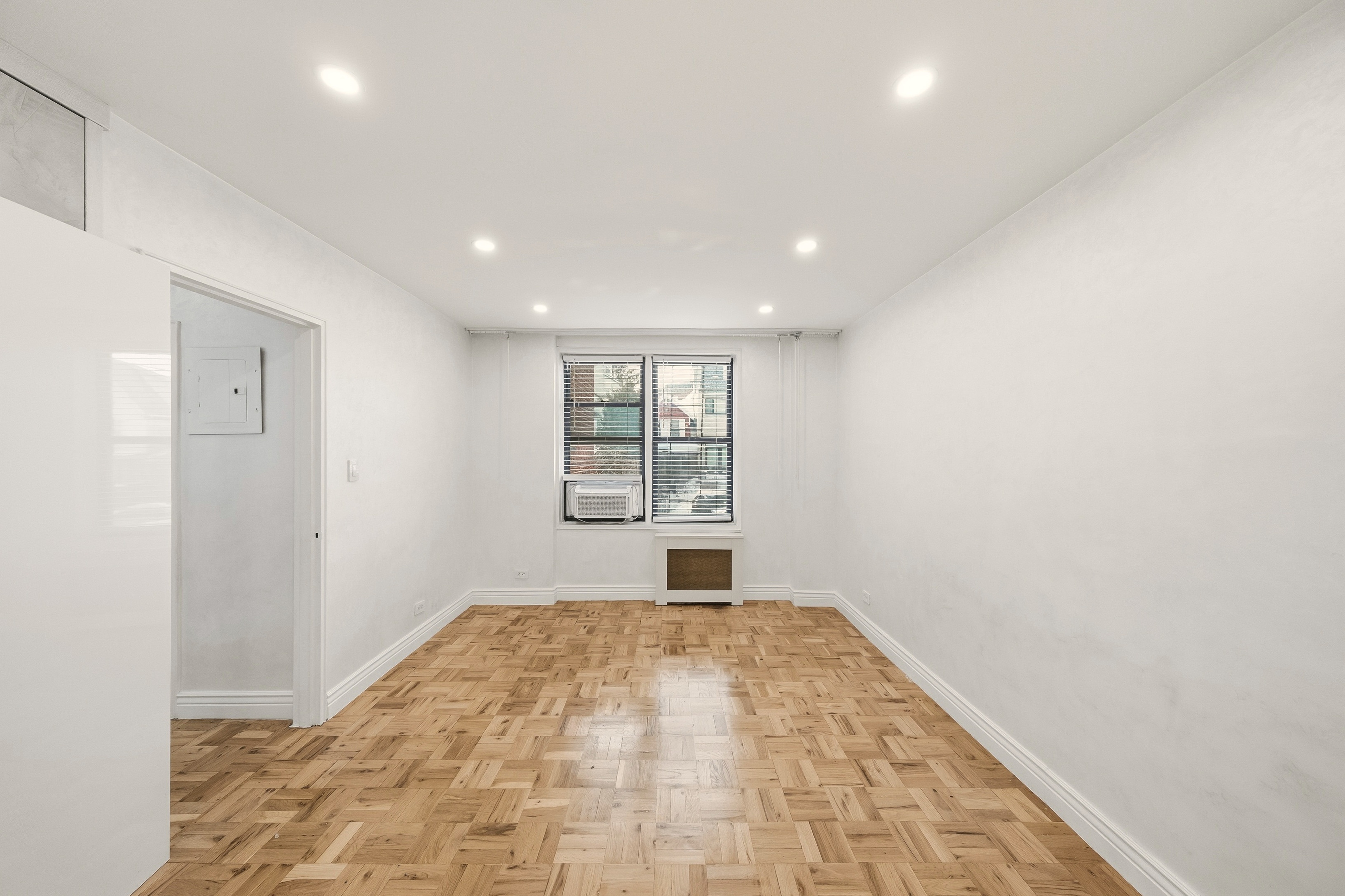 1577 East 17th Street, Unit 2F Brooklyn, NY 11230 - Photo 5 of 21 a view of empty room with wooden floor and fan