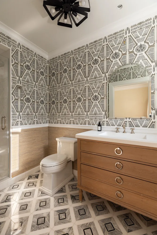 a bathroom with a sink toilet a mirror and shower