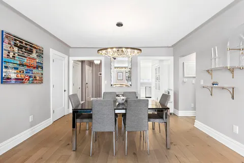 a view of a a dining room with furniture window and wooden floor