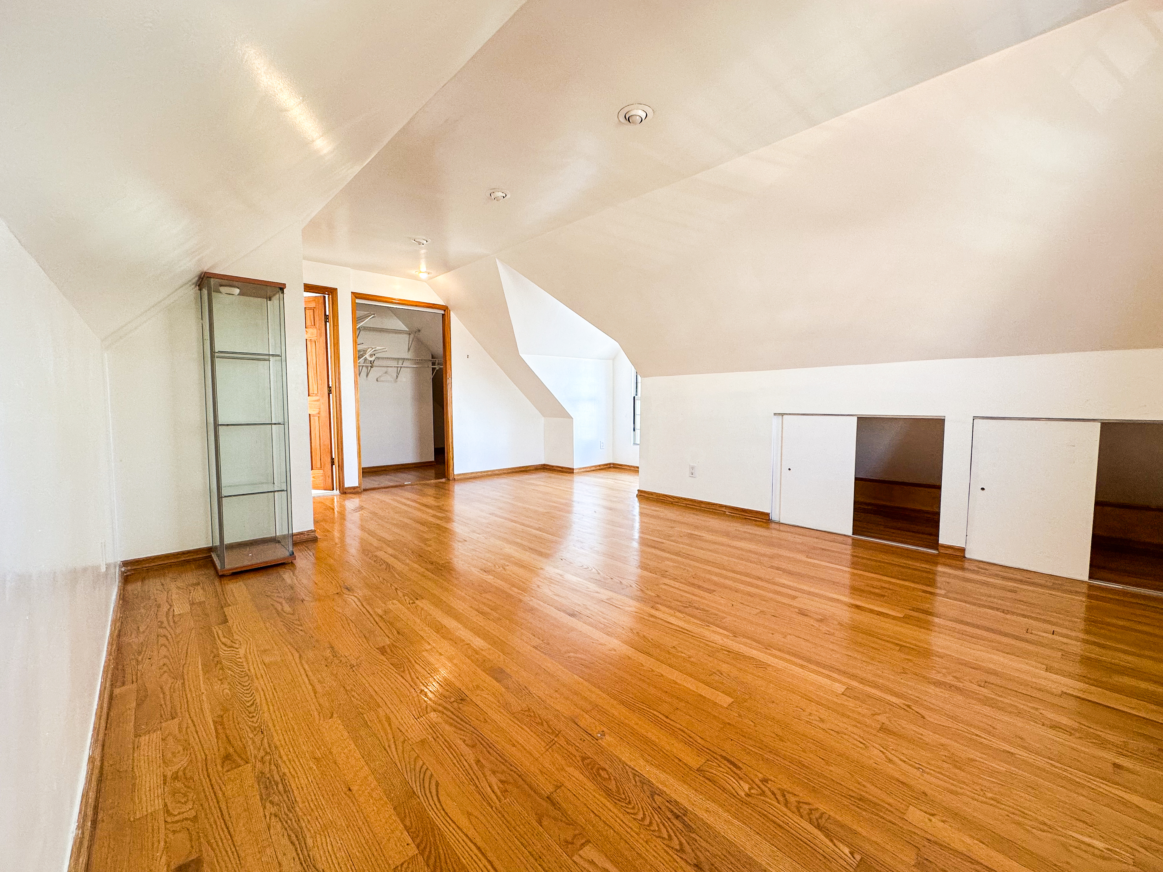 66-42 Clinton Avenue, Unit 2 Queens, NY 11378 - Photo 12 of 14 a view of empty room with wooden floor