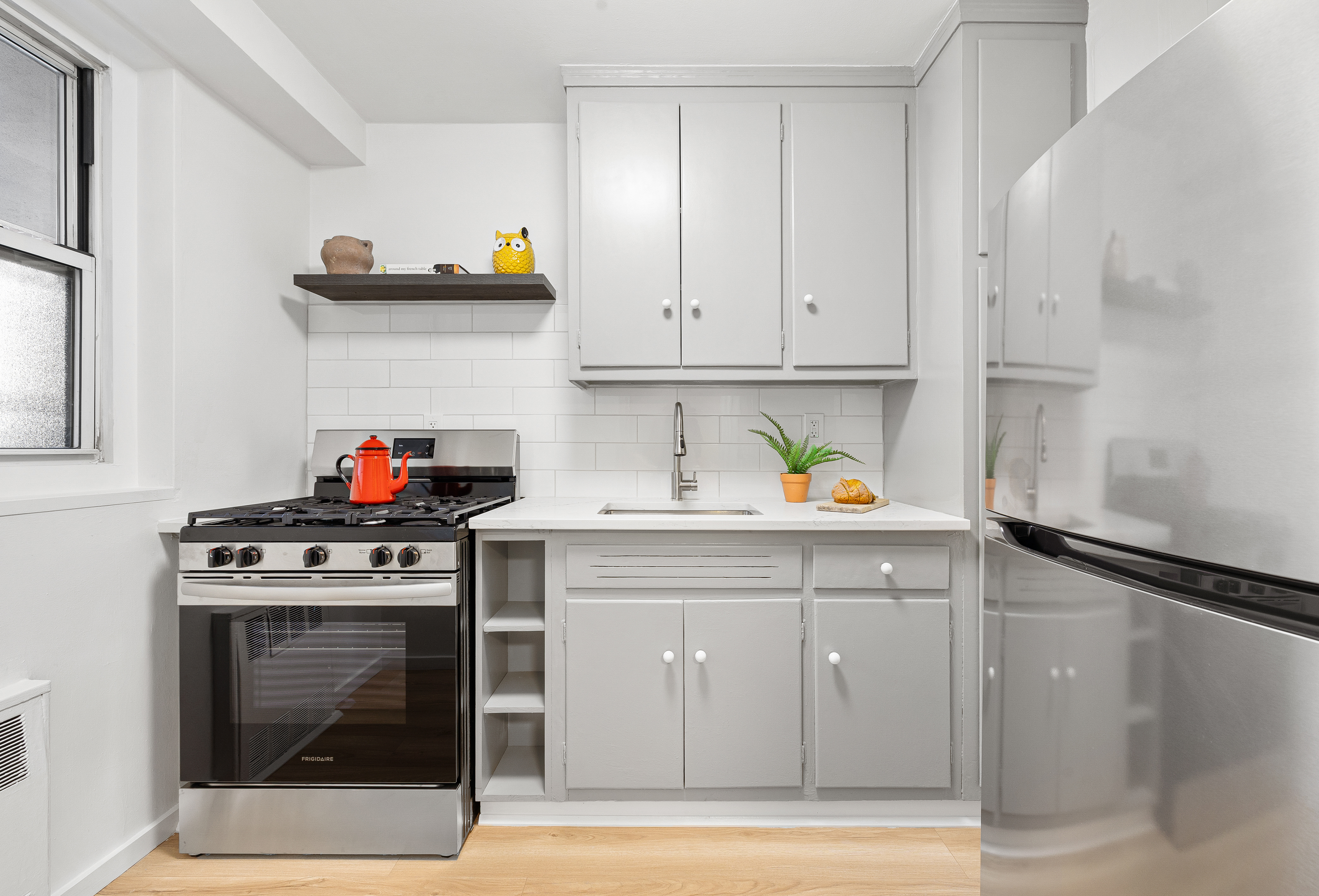 35-51 85th Street, Unit 4M Queens, NY 11372 - Photo 6 of 10 a kitchen with stainless steel appliances granite countertop a stove and a cabinets