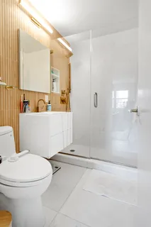 a white toilet sitting next to a bathroom sink