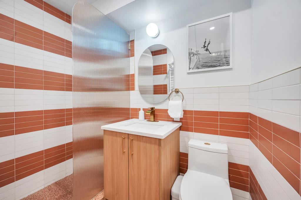 175 West 12th Street, Unit 5E Manhattan, NY 10011 - Photo 18 of 22 a bathroom with a sink a toilet and shower