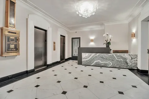 a bedroom with a large bed and a chandelier