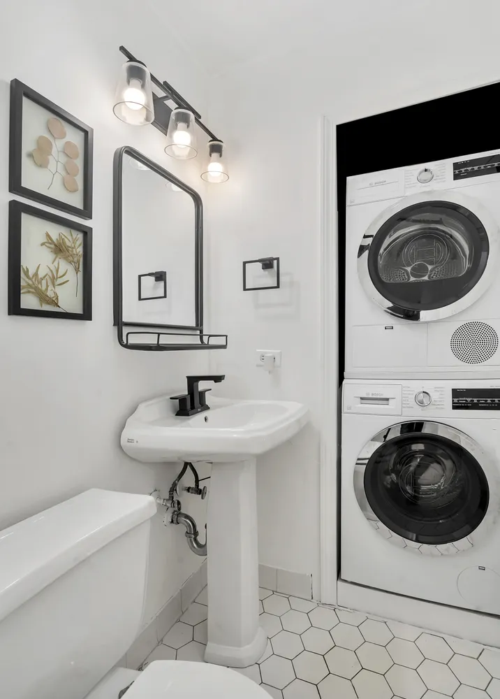 a bathroom with a sink a toilet and a mirror