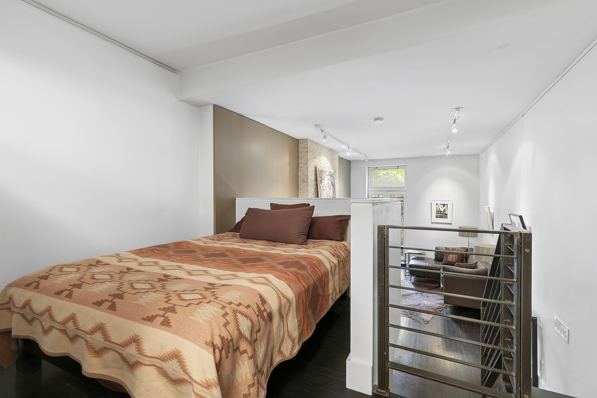 133 East 15th Street, Unit 1B Manhattan, NY 10003 - Photo 8 of 12 a bedroom with a bed and dresser