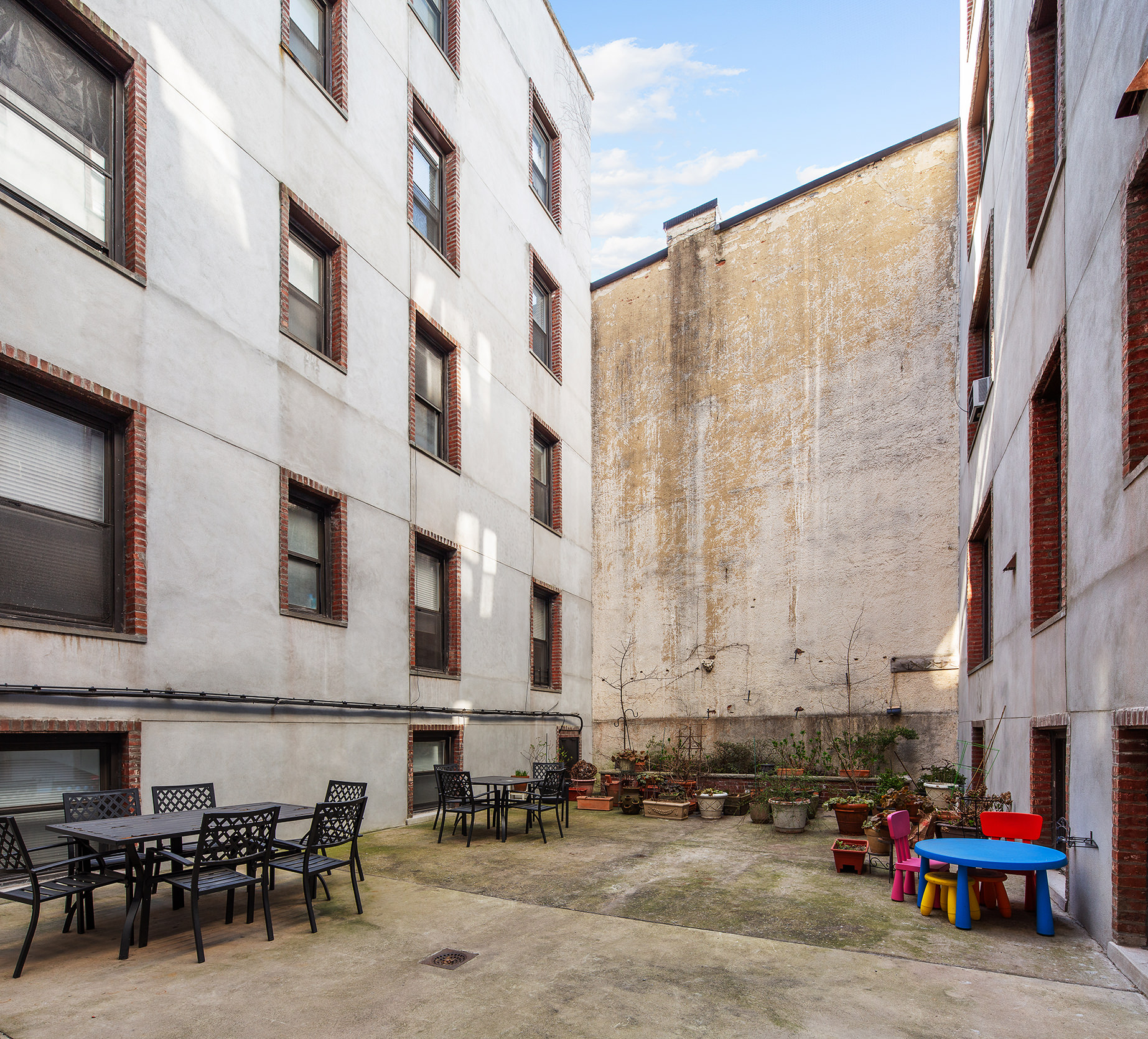 310 Windsor Place, Unit 32 Brooklyn, NY 11218 - Photo 15 of 19 a building with car parked in front of it