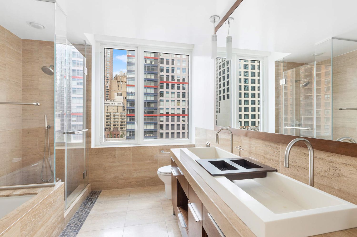 250 East 53rd Street, Unit 1001 Manhattan, NY 10022 - Photo 9 of 18 a kitchen with a sink and a large window