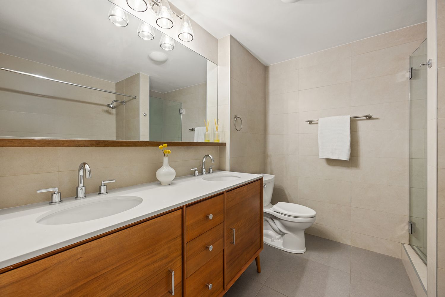 a bathroom with a granite countertop sink a toilet and a mirror