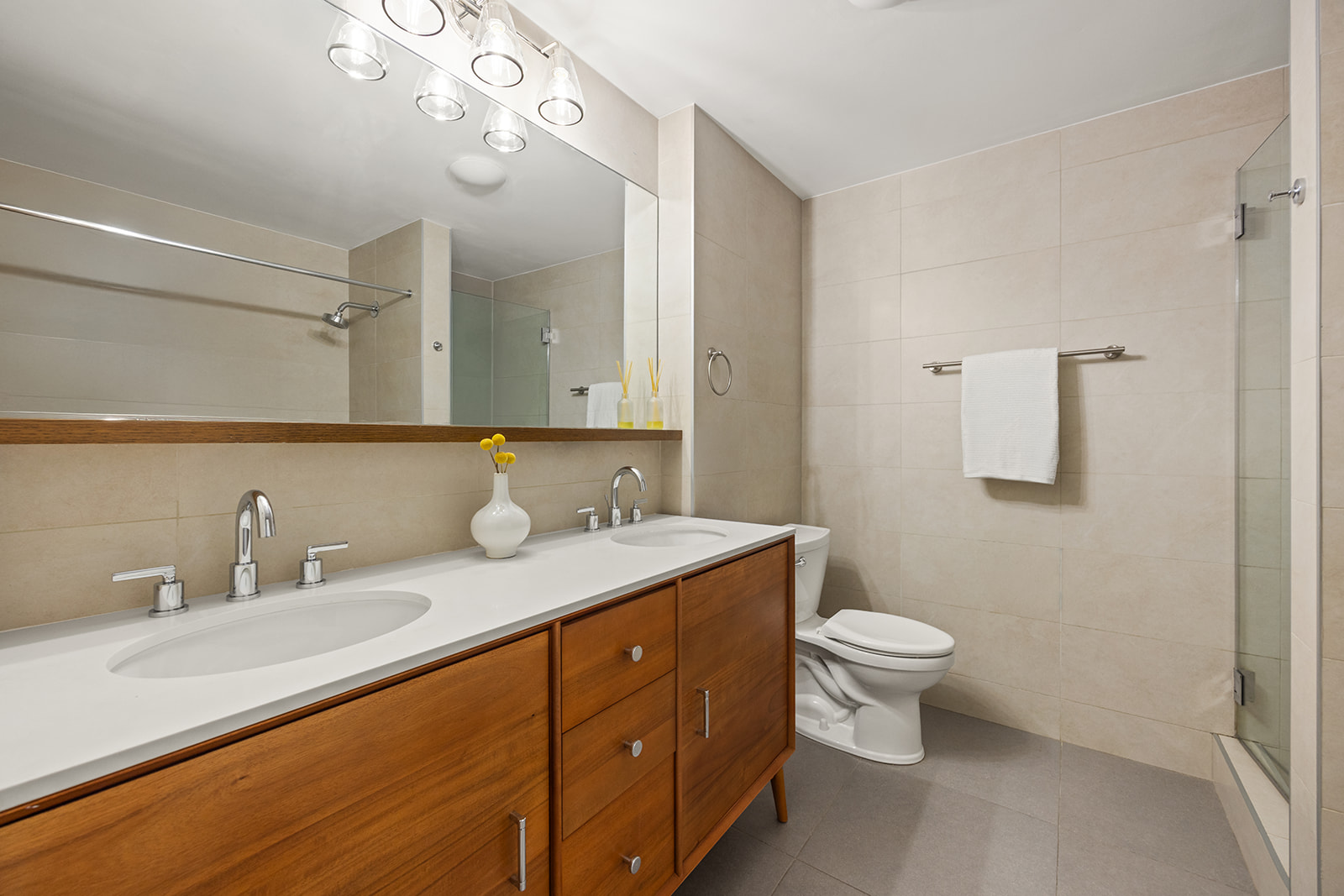 133 Water Street, Unit 5A Brooklyn, NY 11201 - Photo 7 of 13 a bathroom with a granite countertop sink a toilet and a mirror