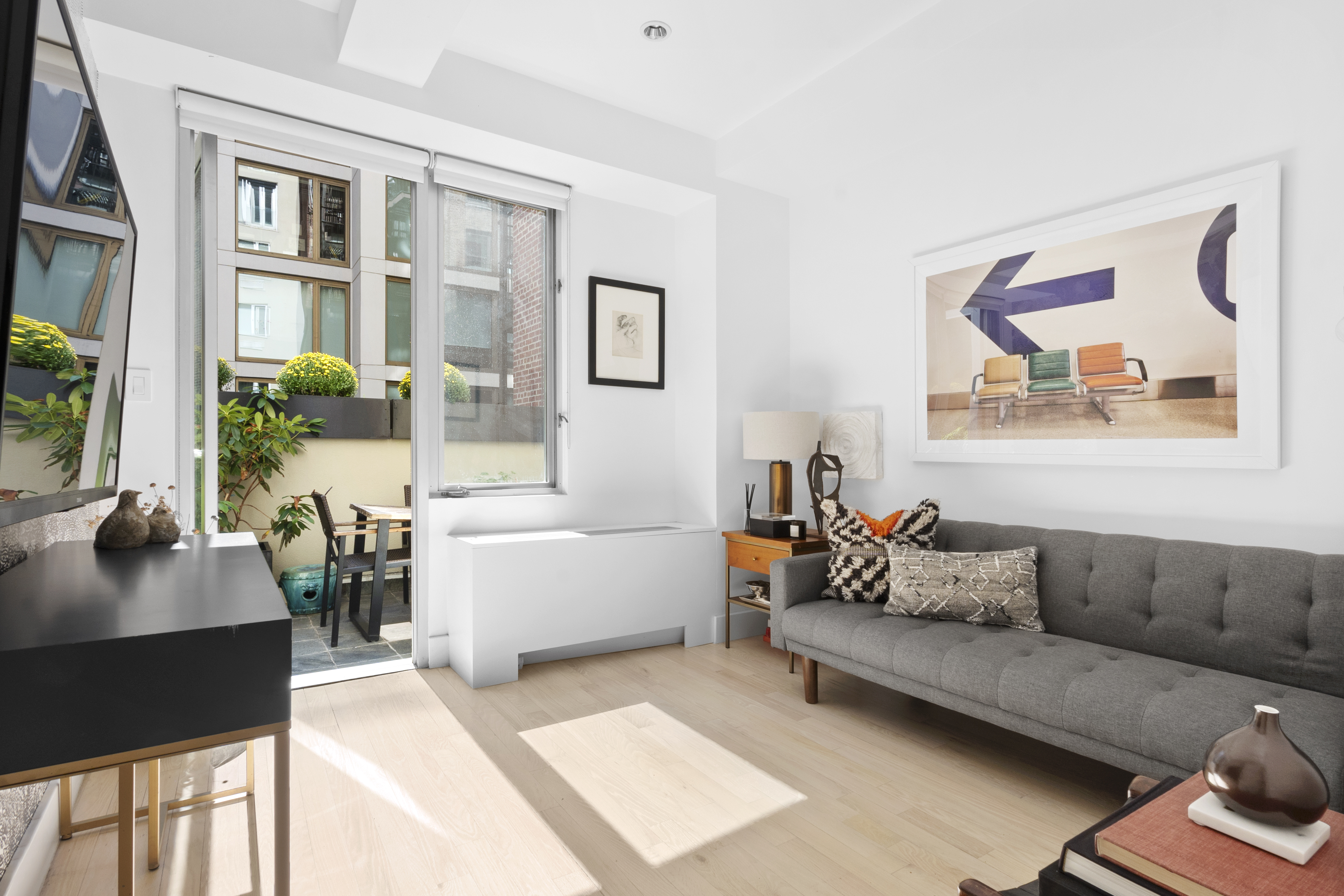 116 West 22nd Street, Unit 5 Manhattan, NY 10011 - Photo 9 of 15 a living room with furniture and a large window