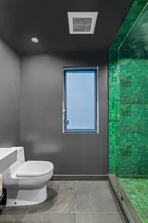 a bathroom with a toilet a sink and garden view