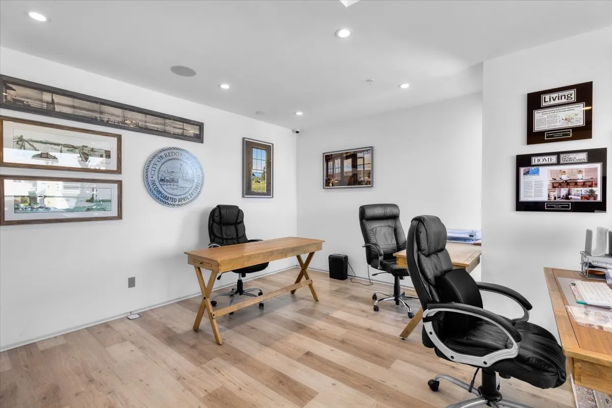 a view of a workspace with furniture and a window