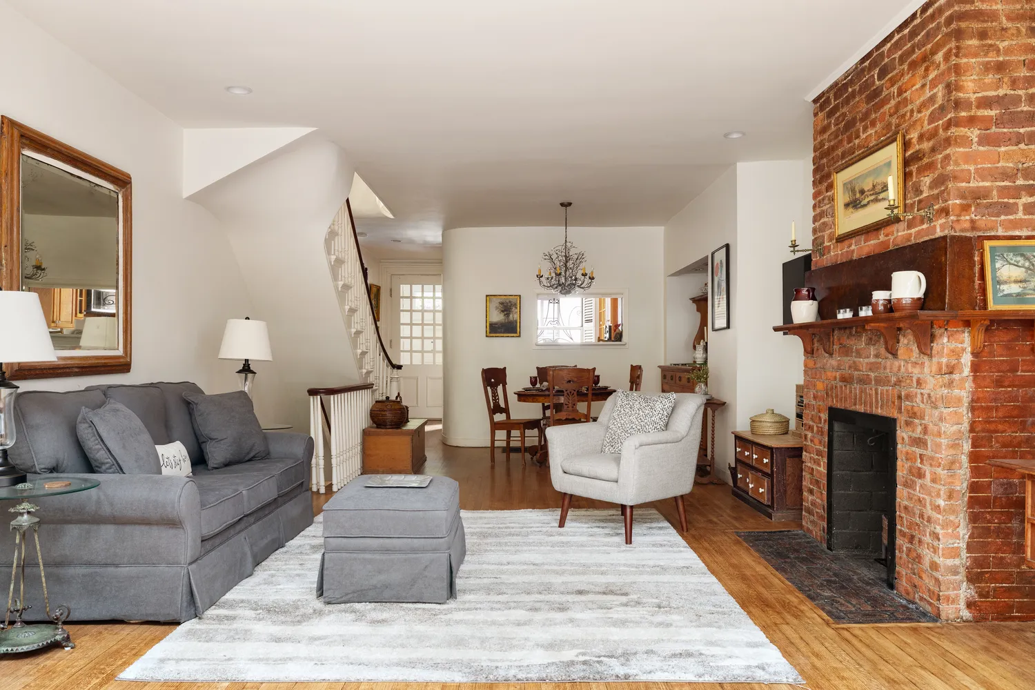 a living room with furniture a fireplace and a chandelier